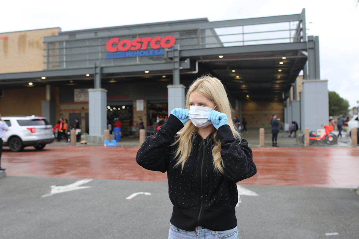 woman wearing face mask and gloves at costco grocery store