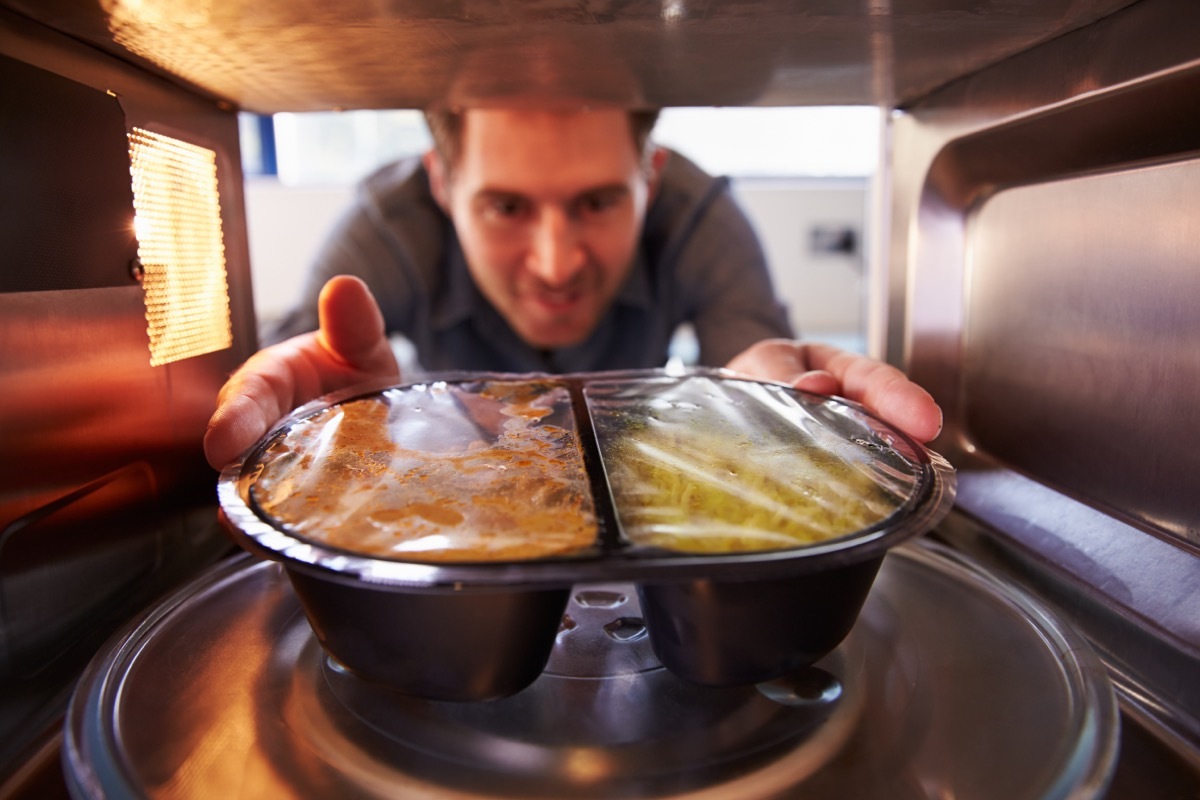 Man heating prepackaged dinner