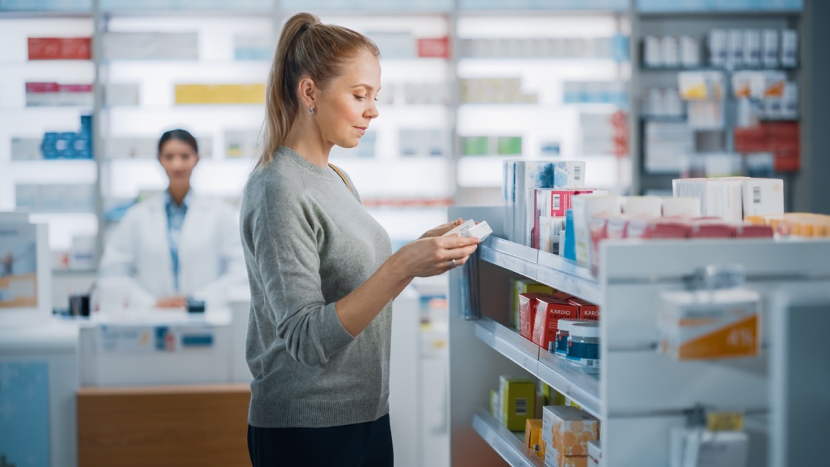 woman choosing otc meds at drugstore