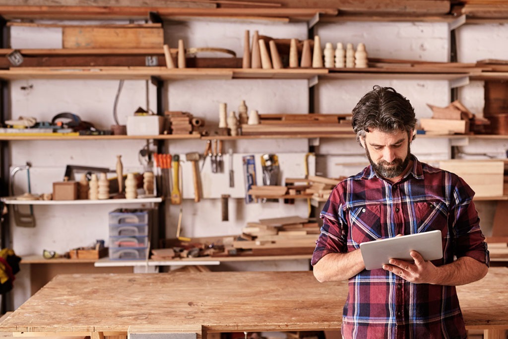 healthy man in garage working with tools