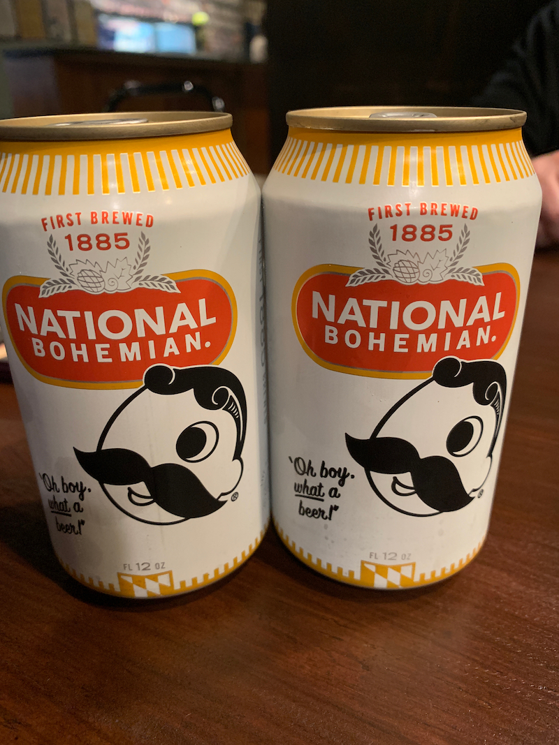 Two unopened ice cold cans of Natty Boh aka National Bohemian