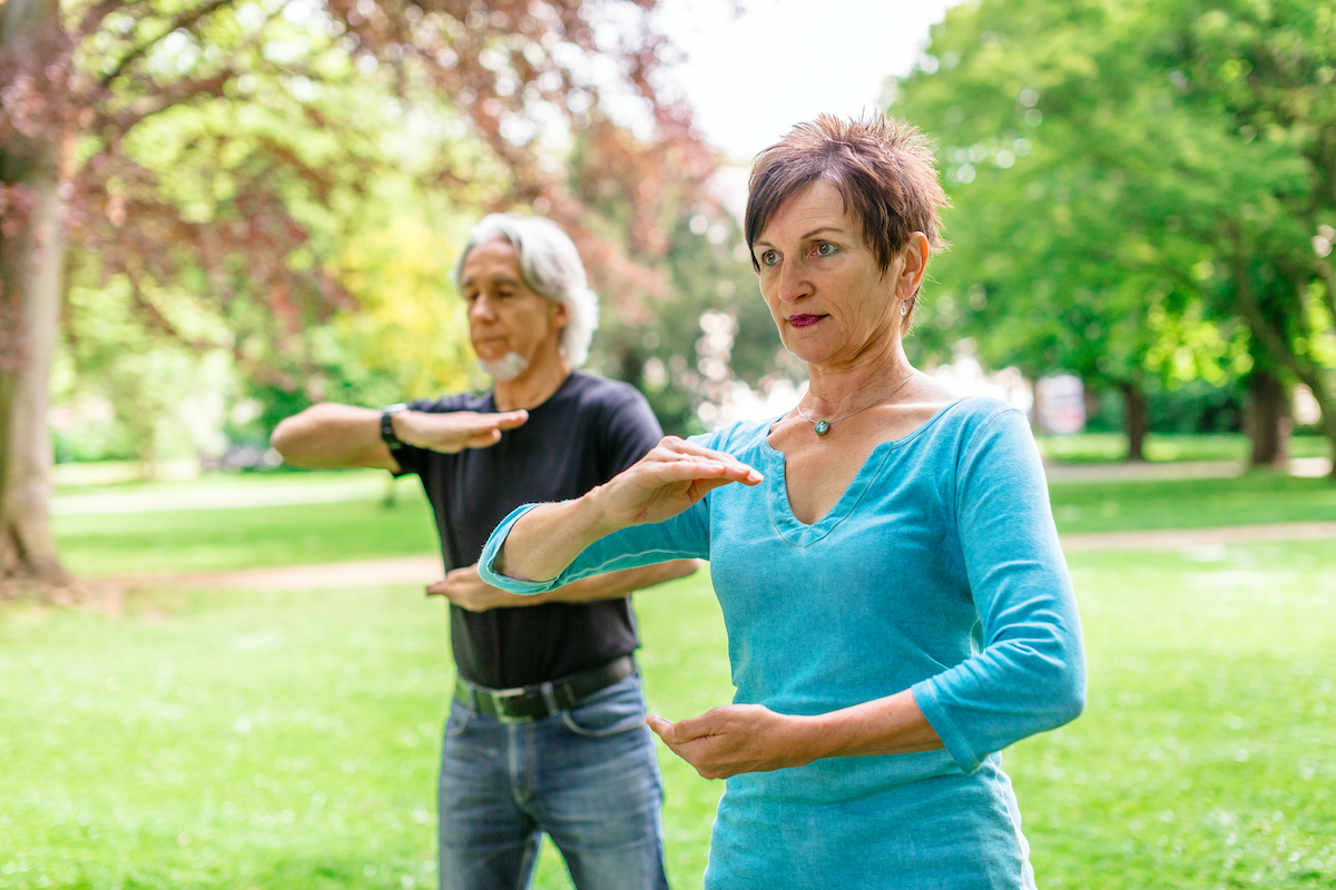 Senior Couple Doing Tai Chi In Park, Tuebingen, Germany