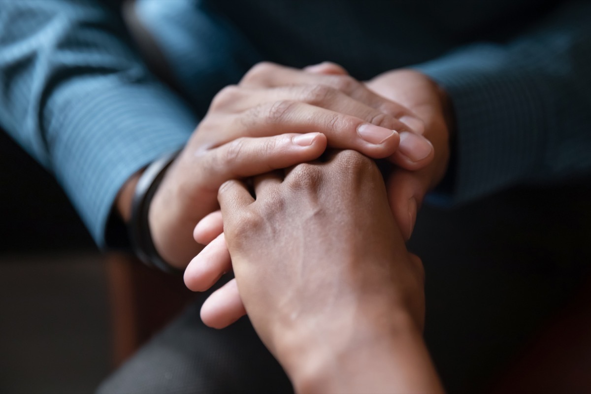 Close up of young couple hold hands