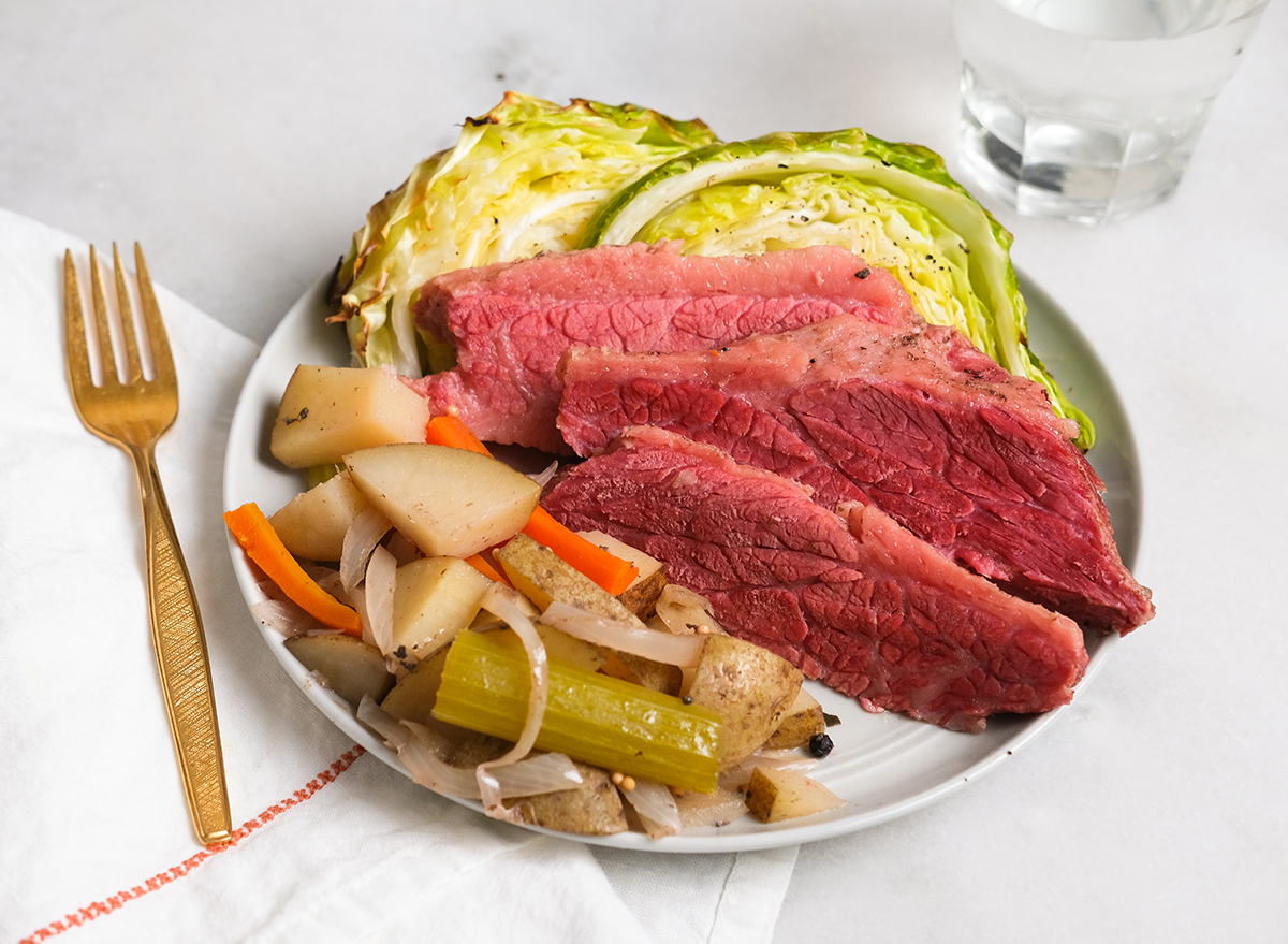 corned beef and cabbage on a plate with potatoes and vegetables