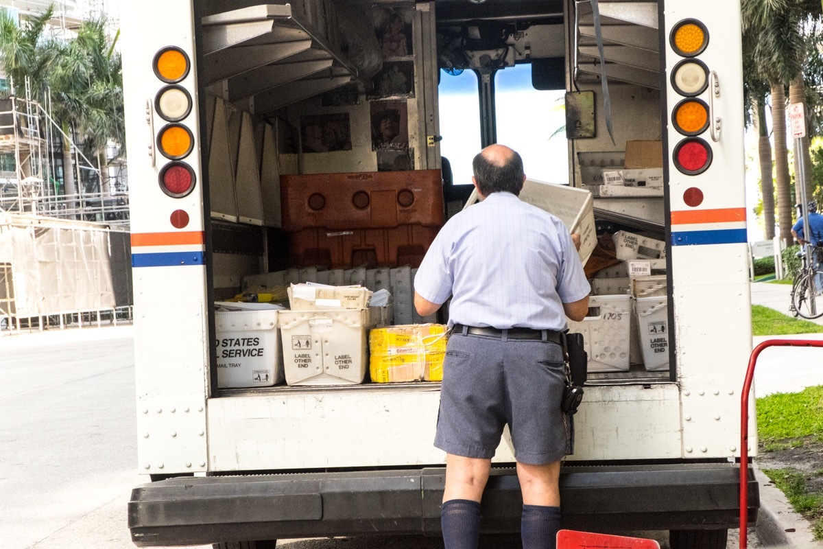 Postman unloading the truck delivering the mail in Miami, Fl. In the more than two centuries since Benjamin Franklin was appointed US first Postmaster General in 1775, the Postal Service™ has grown and changed with America, boldly embracing new technologies to better serve a growing population.