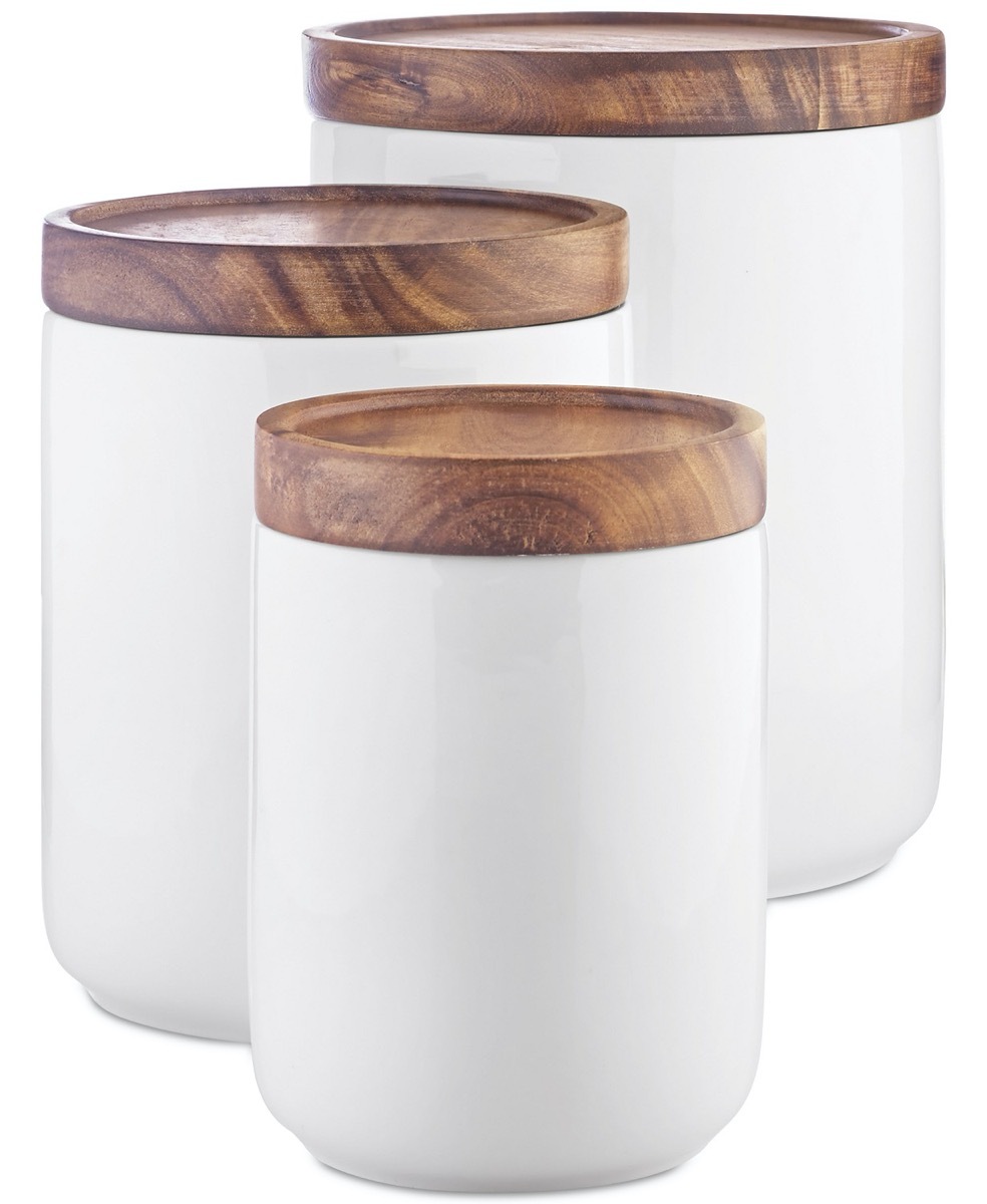 white canisters with wooden tops