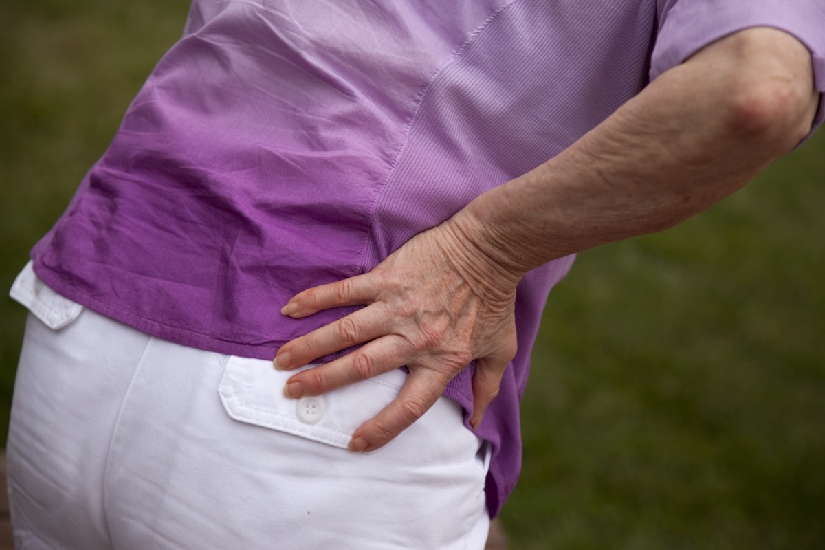 woman holding strained back