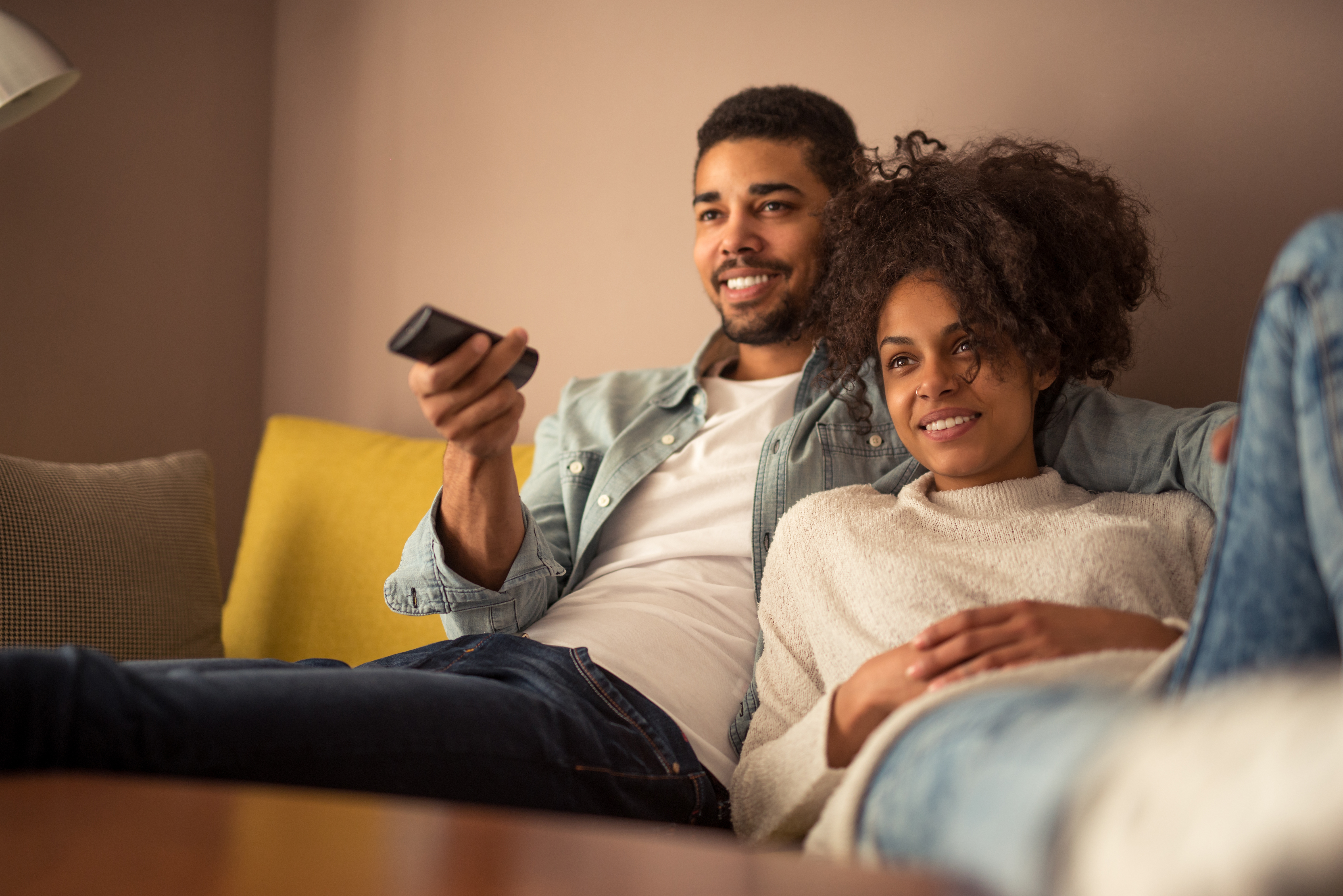 man and woman watching TV