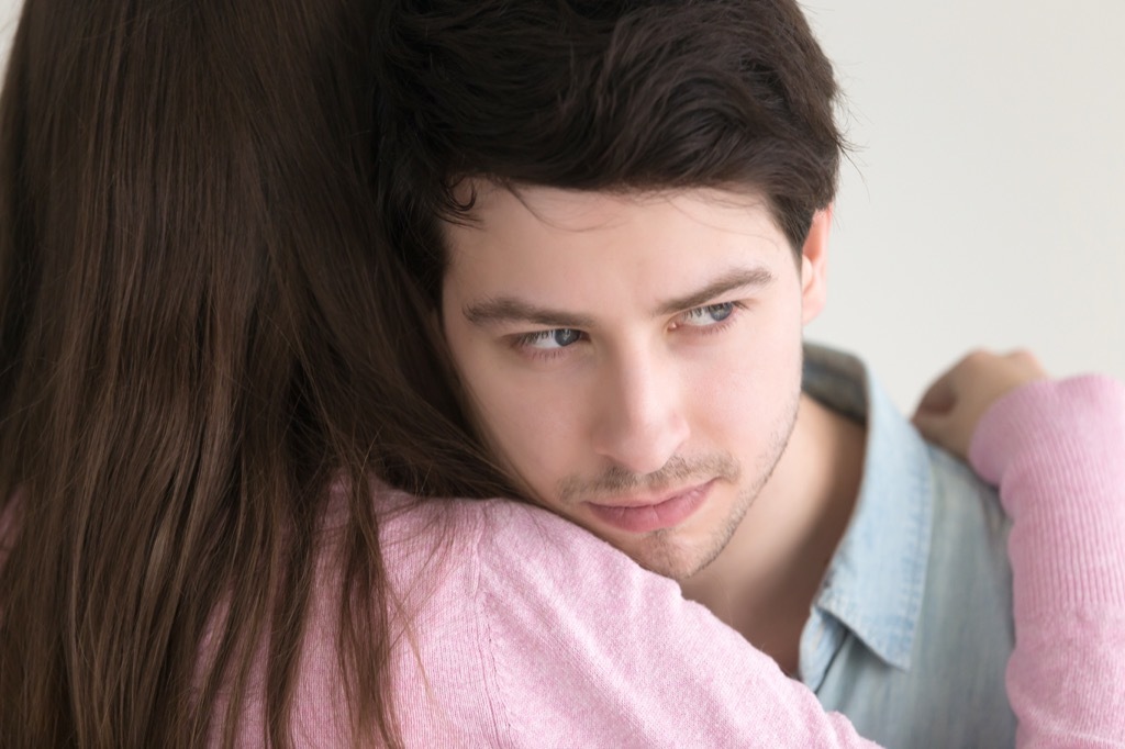 Guy is giving a girl a fake hug.