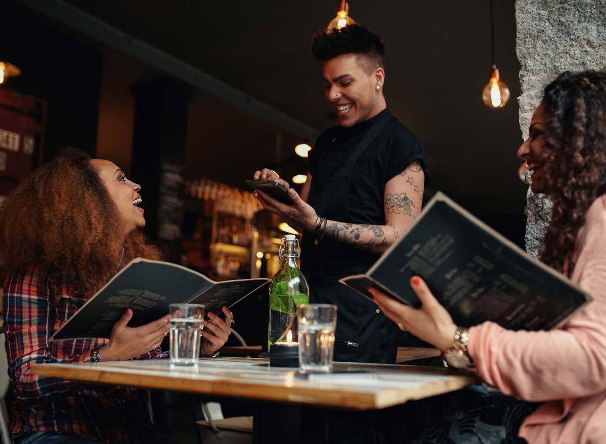 Waiter playing favorites with a customer as they order.