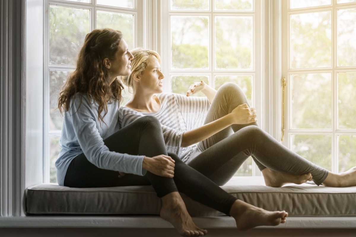 lesbian couple cuddling and talking to each other