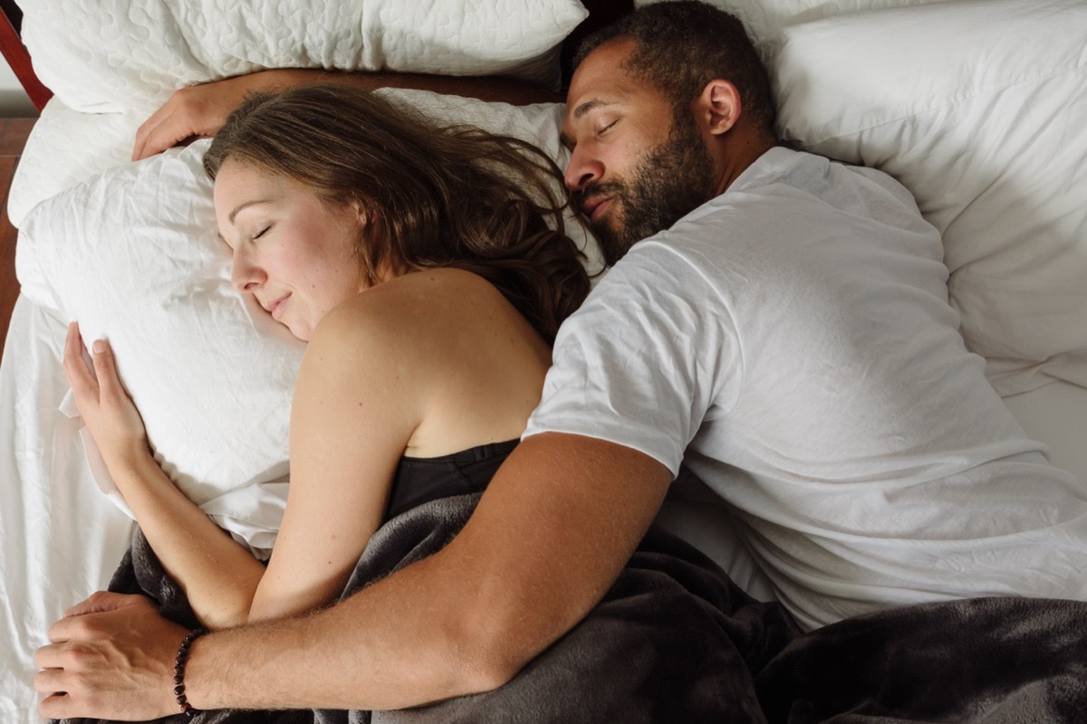 couple spooning in bed