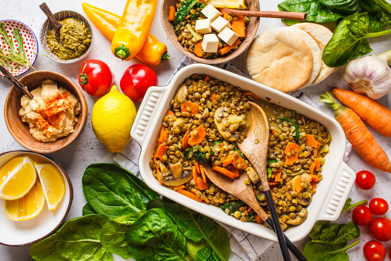 Vegan lentil curry with vegetables, top view. Healthy vegetarian food background.