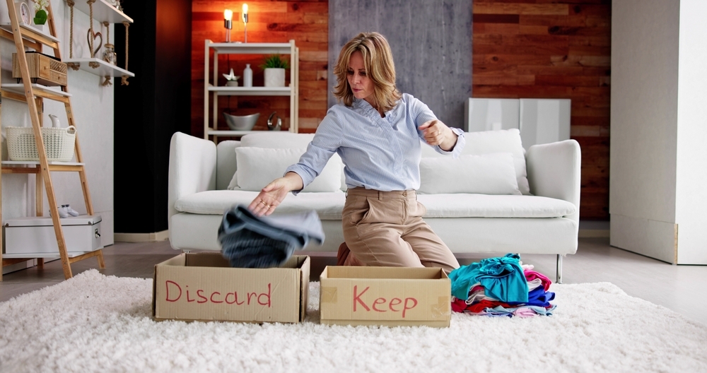 Stylish senior woman cleaning out and organizing her closet