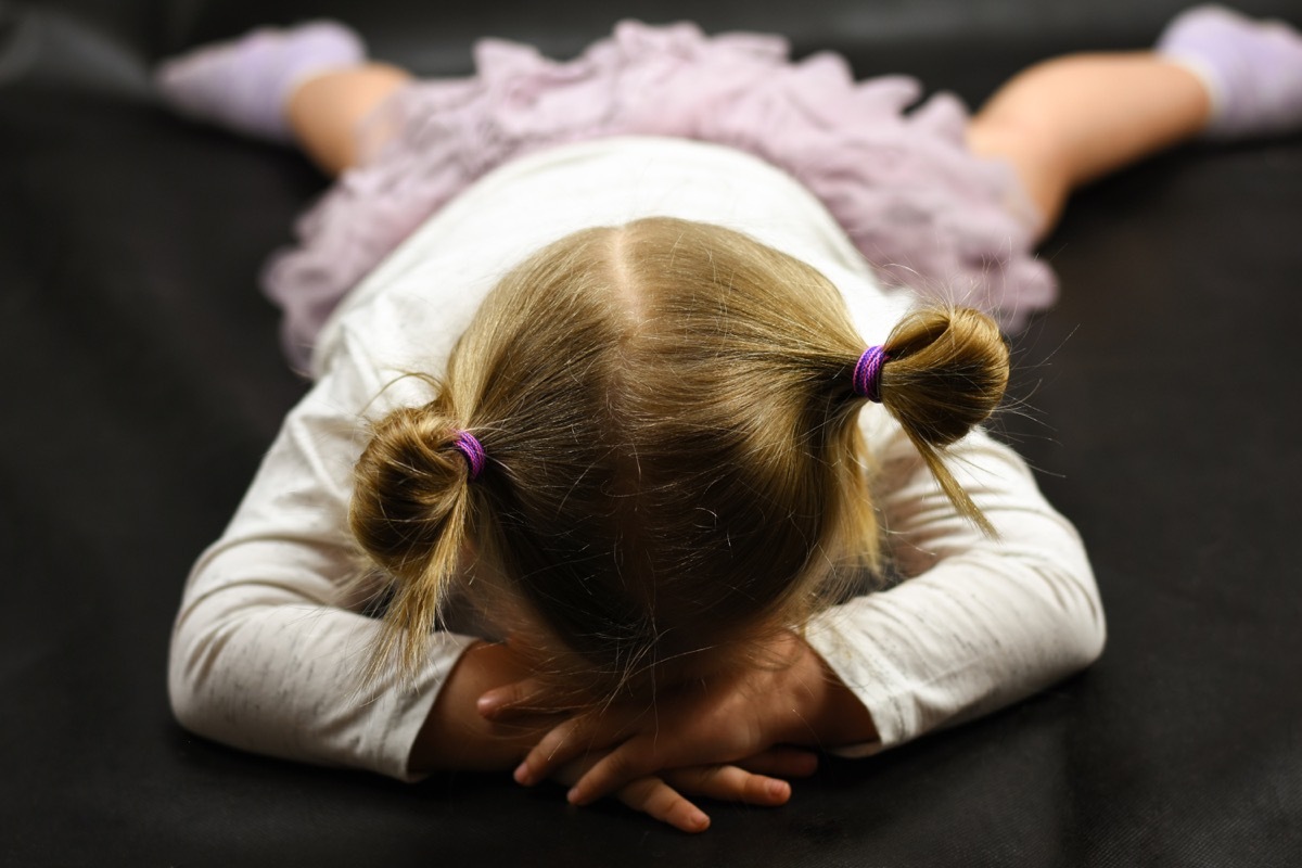 Toddler girl throwing a tantrum laying down