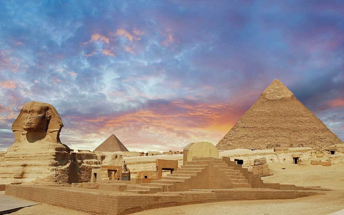 a view of the Egyptian pyramids at dusk