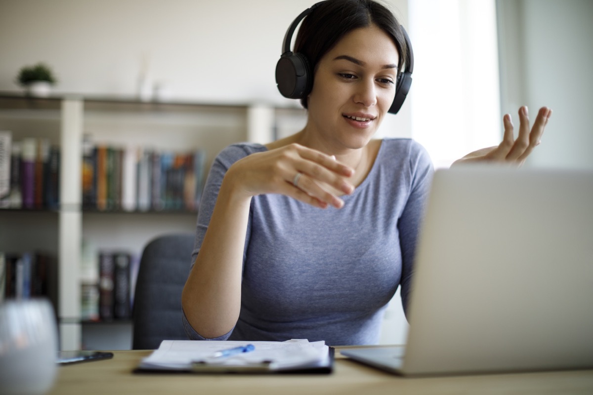 woman talking animatedly while on her laptop