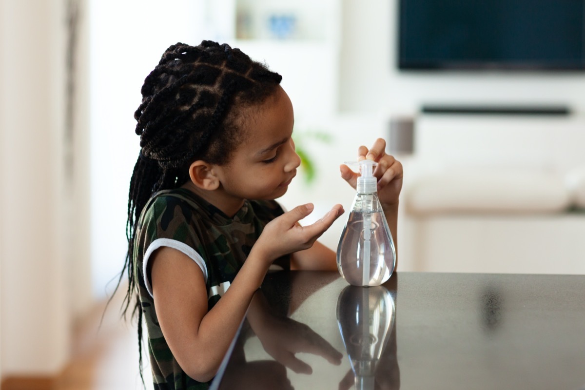 children hand using antibacterial antiseptic hand sanitizer gel