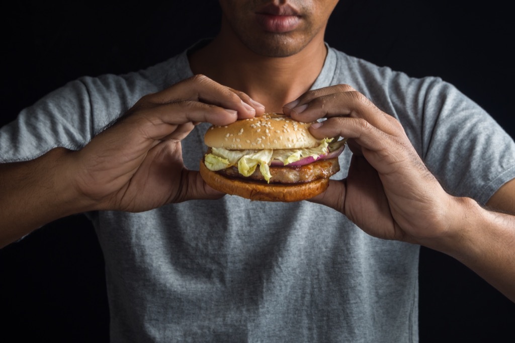 Man holding a hamburger