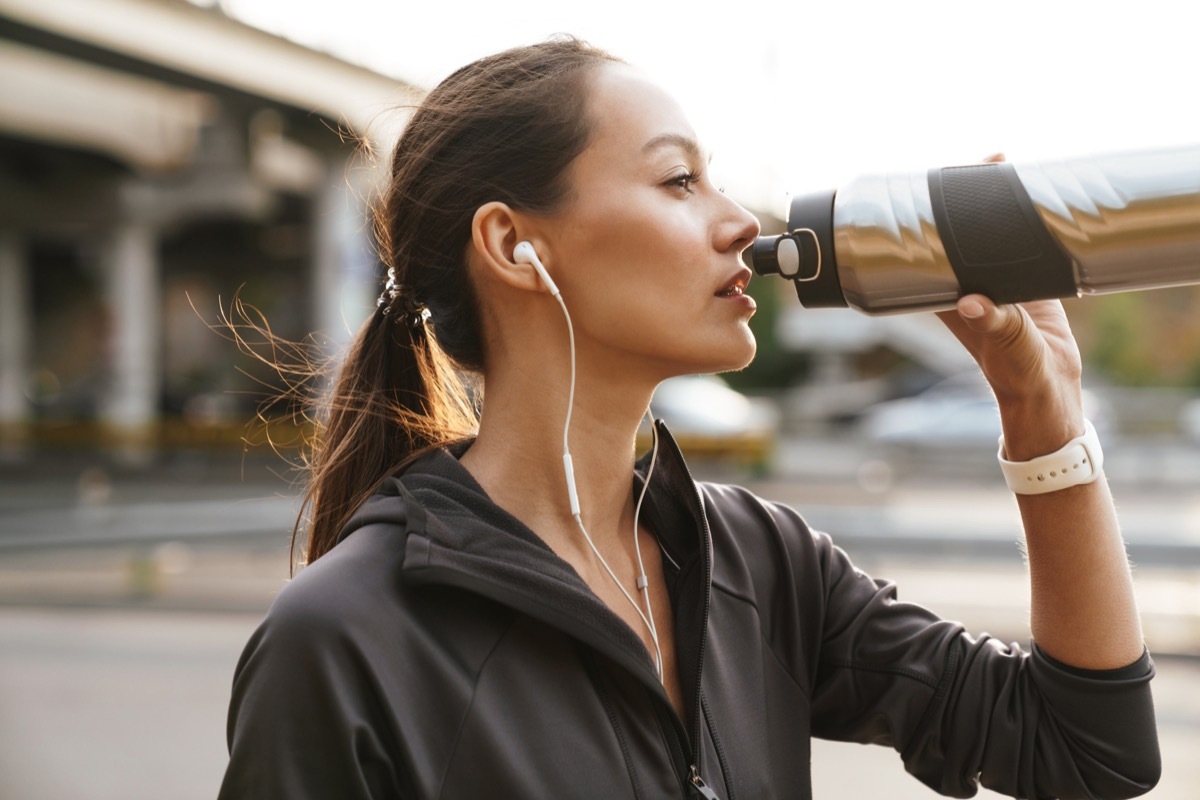 Woman drinking water during exercise