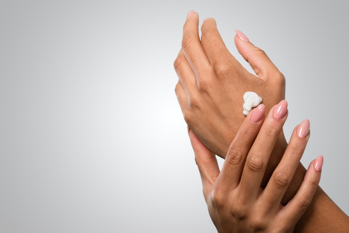 female hands applying cream