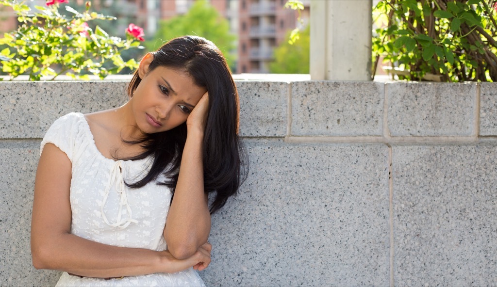 sad woman sitting outdoors, parent divorce