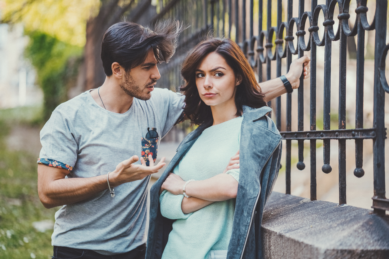 Unhappy couple outside talking about problems