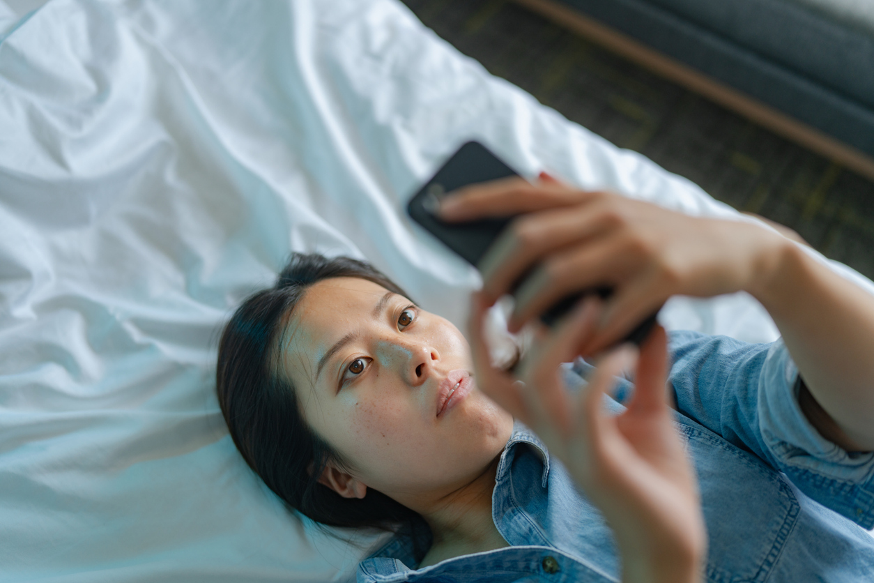 young Asian woman shopping on her phone