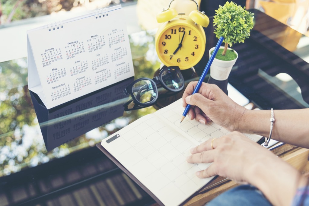 woman writing in planner New Year's Resolutions