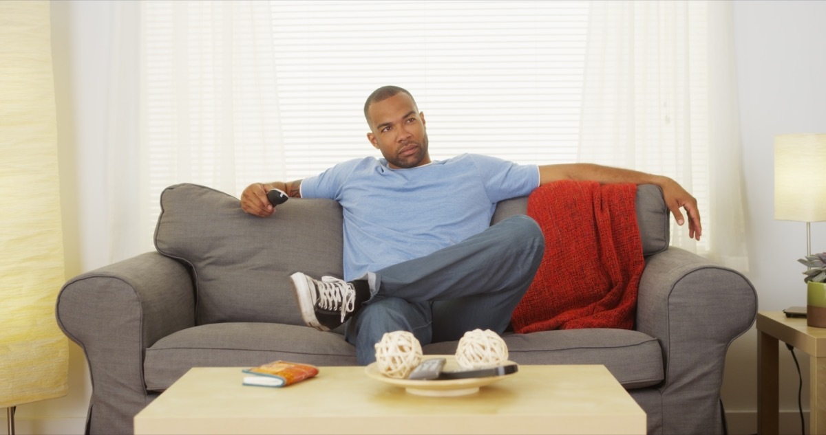 Man relaxing watching tv on his couch