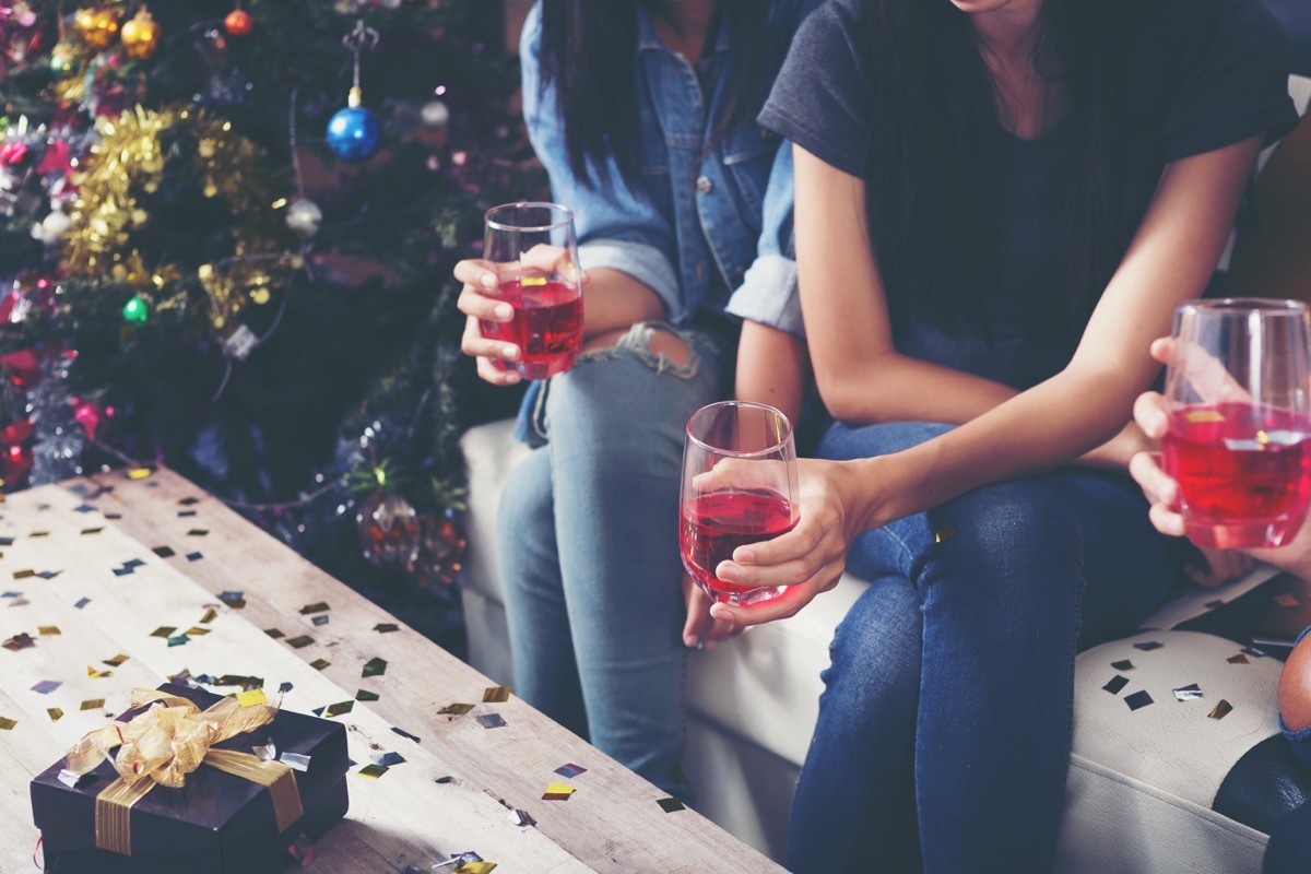 group of adults holding their drinks at a christmas party