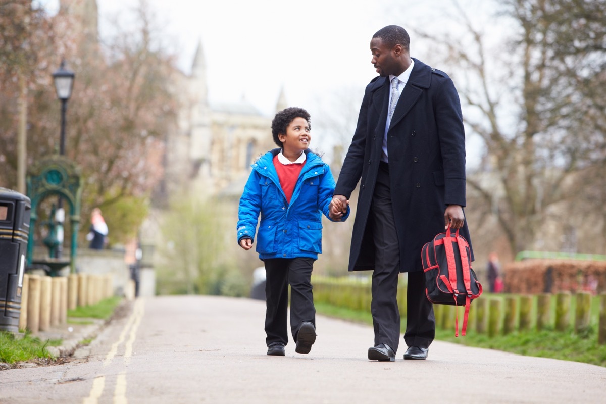 father picking up his child son from school and carrying his backpack, parent divorce