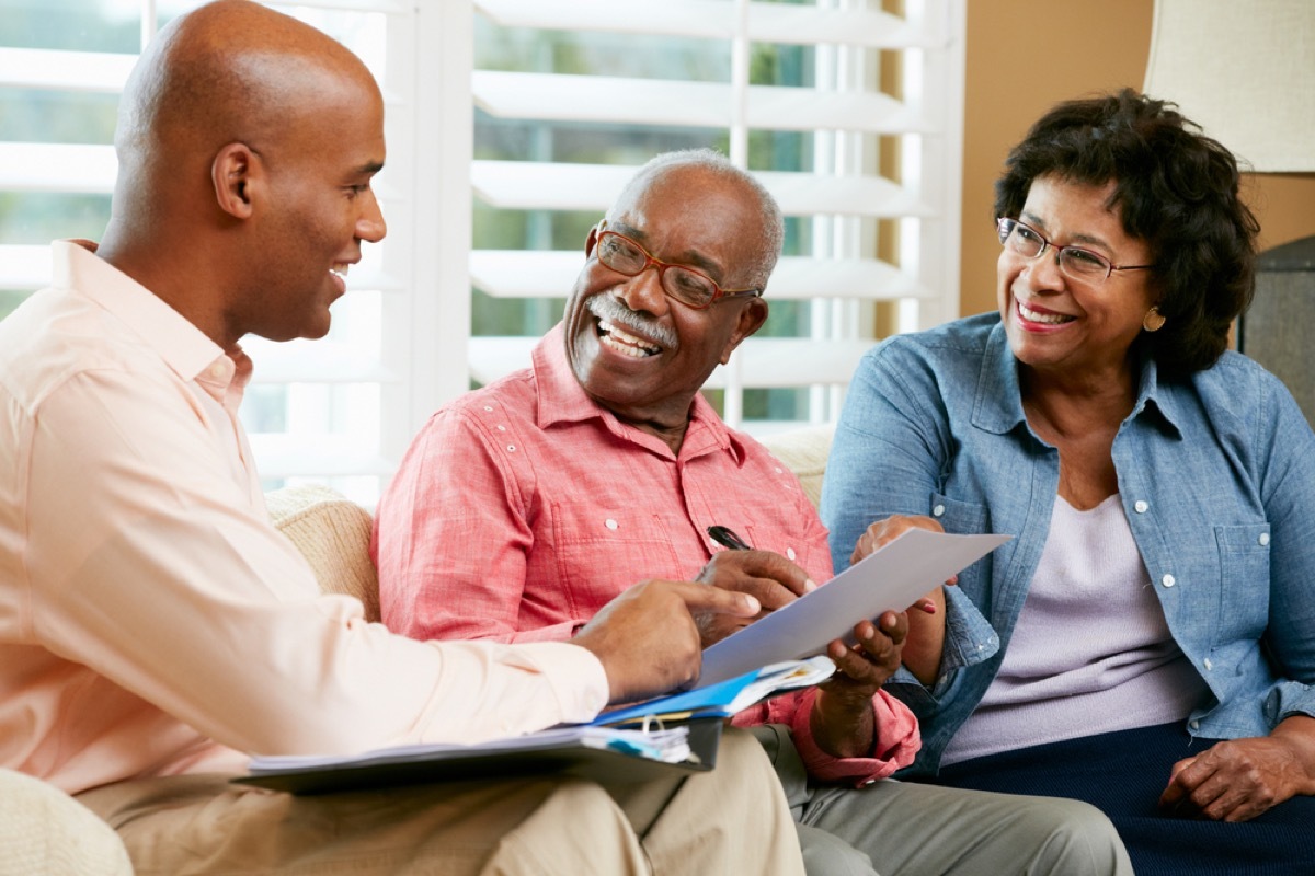 older couple speaking with financial professional, downsizing your home