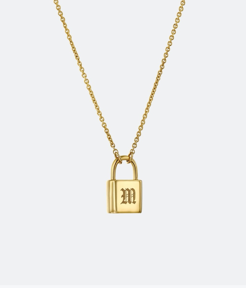 gold necklace with lock bearing the letter M on it