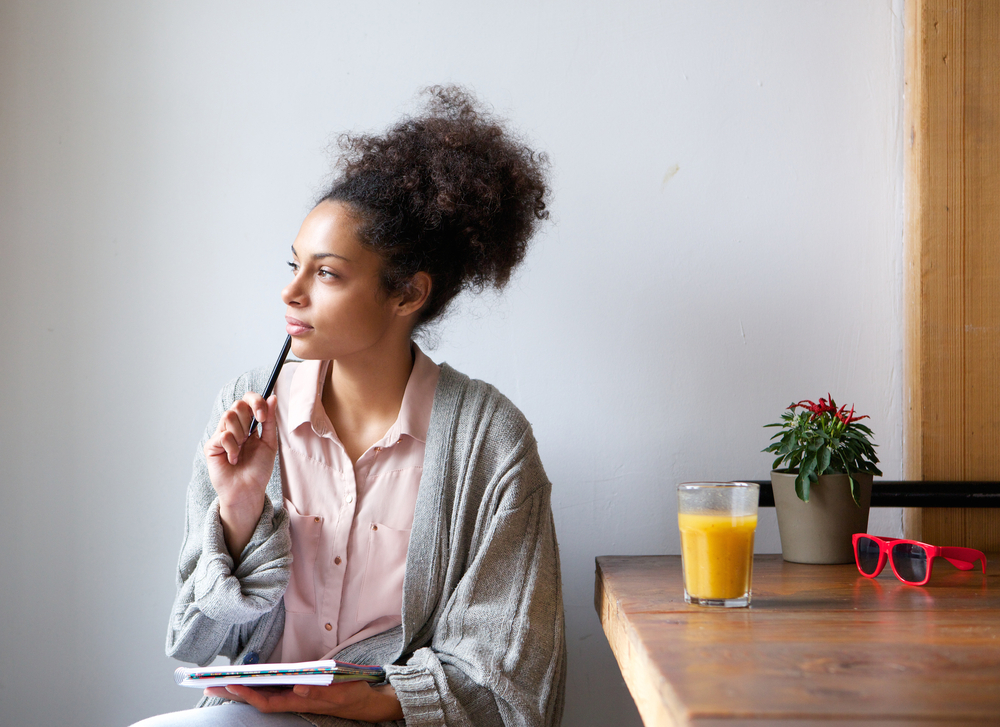 woman sitting at a table thinking