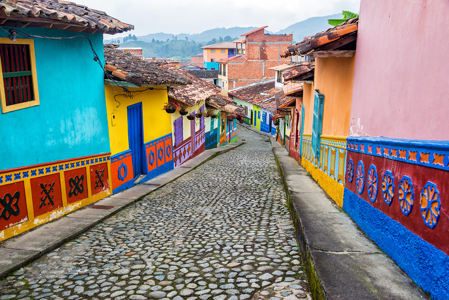 Colorful colonial houses on a cobblestone street in Guatape, Antioquia in Colombia