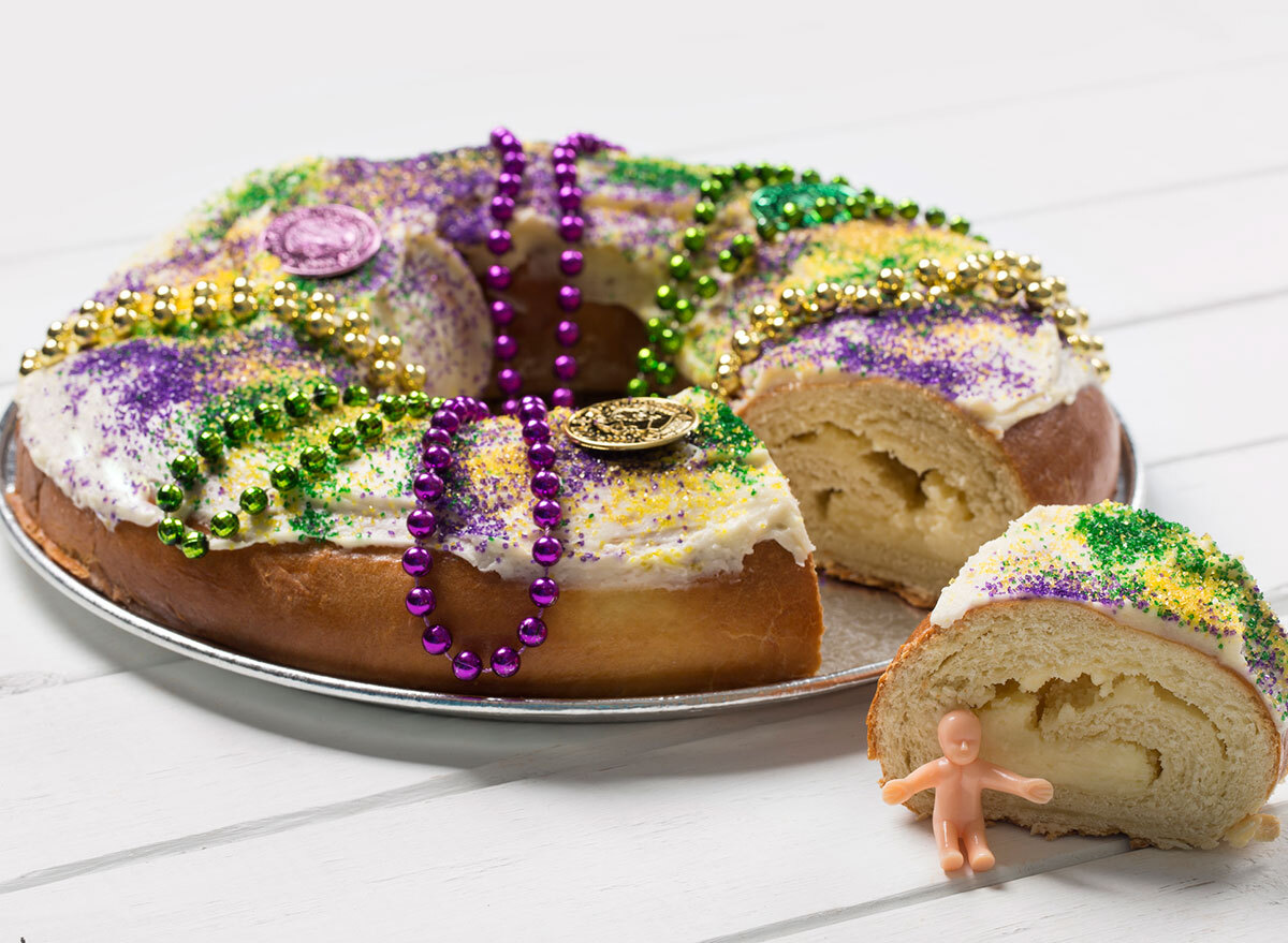 king cake with slice and plastic baby