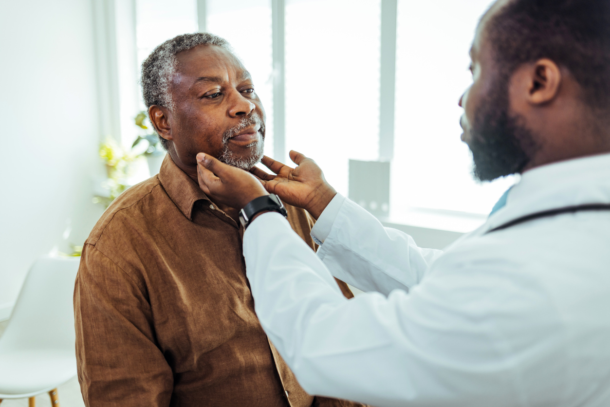 Doctor performing throat exam on patient.