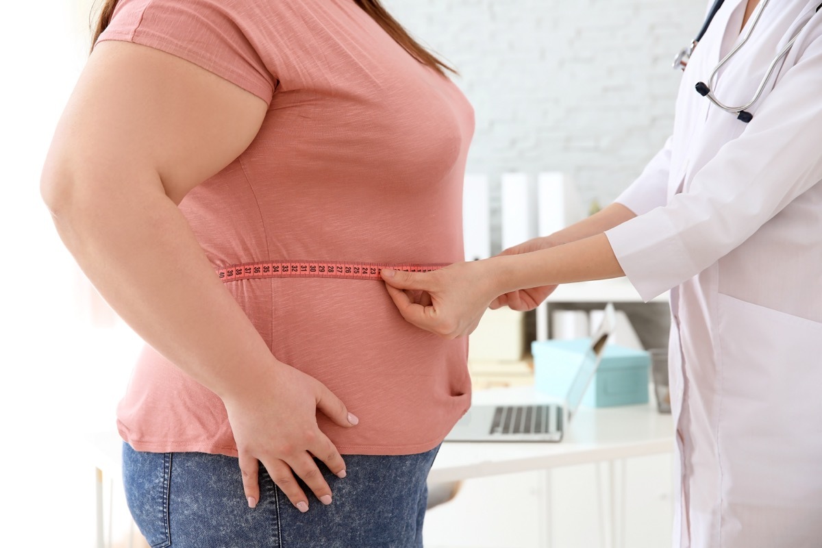 Woman getting measured by doctor