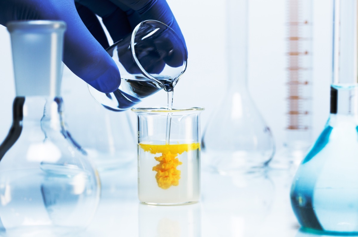 Chemical reaction. Two clear liquids are mixed to produce a yellow precipitate.