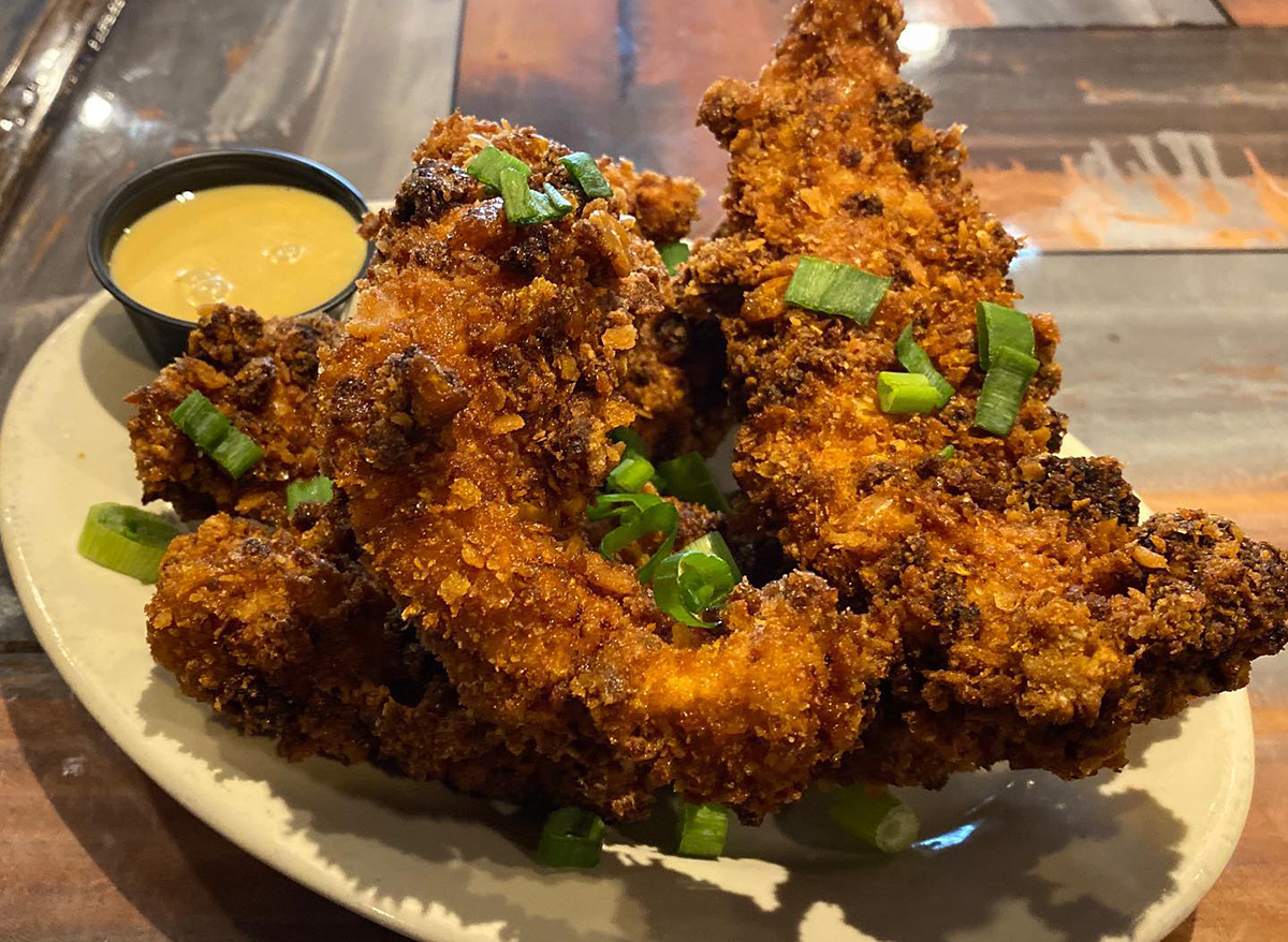 pile of chicken tenders with dip