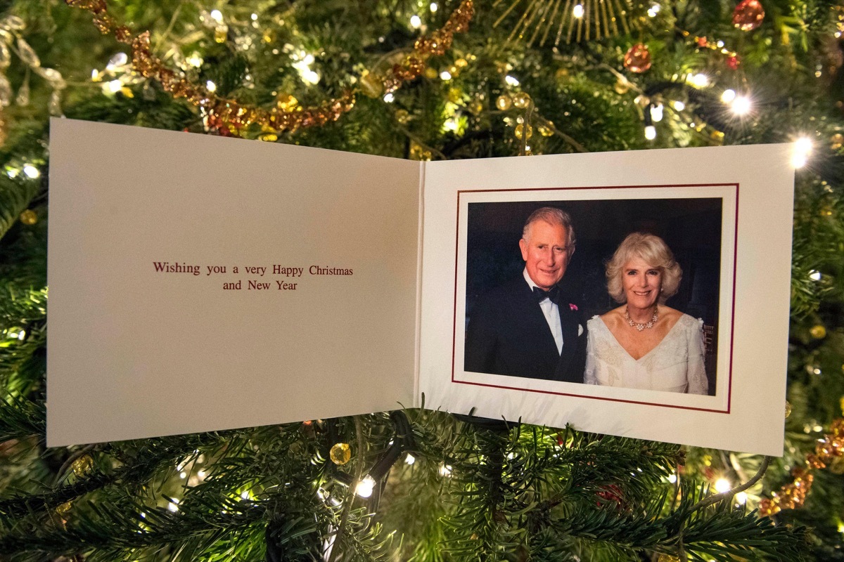 The Prince of Wales and Duchess of Cornwall's 2017 Christmas card on a Christmas tree in Clarence House, London. The picture on the card was taken by Hugo Burnand showing the royal couple in the Orchard Room during the private 70th birthday party of The D