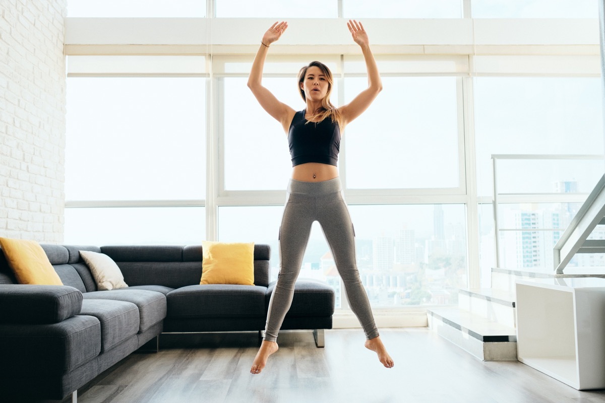 Woman jumping and workout out in the living room