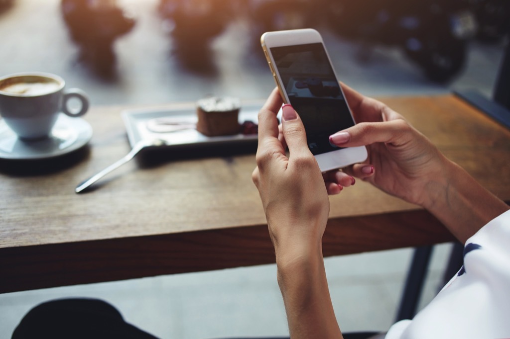 woman on her phone at a restaurant