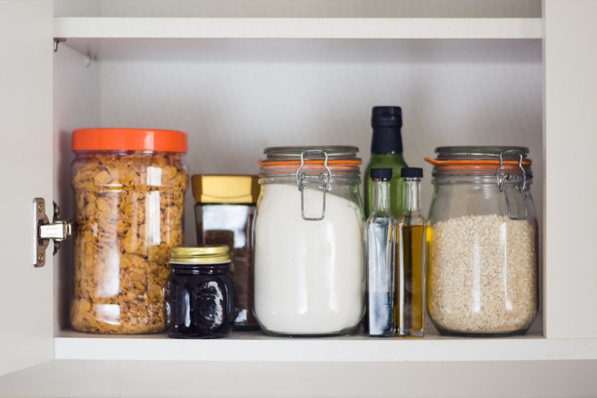 Organized pantry jars in cabinet