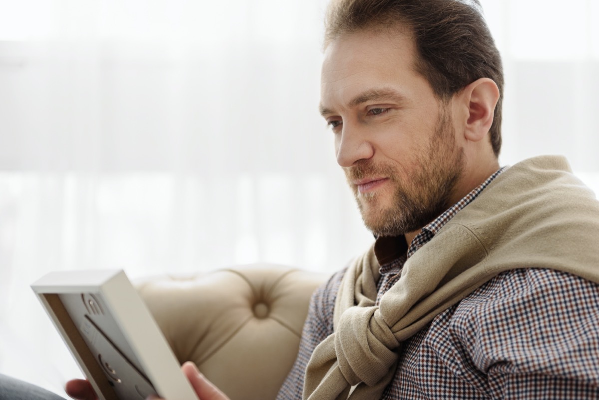 middle age man looking at a photo