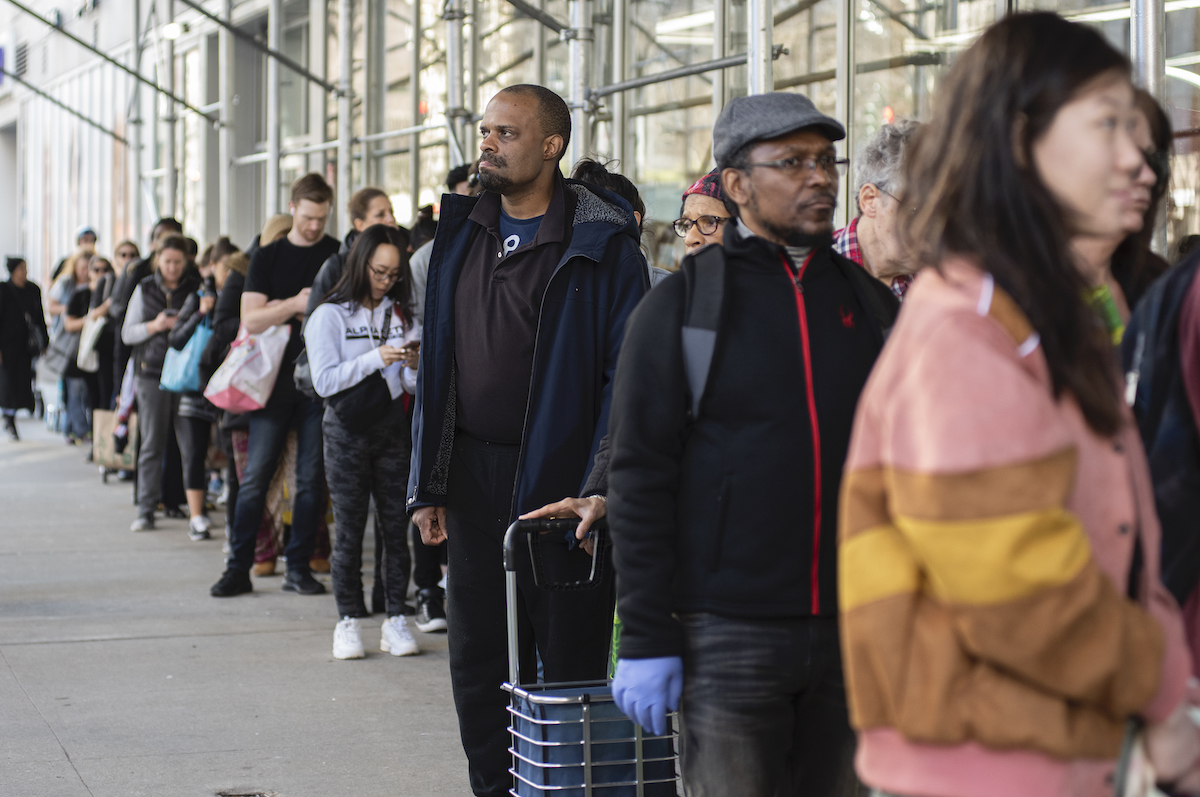 People make line up to buy supplies at Manhattan supermarkets, After president Donald Trump speech to the nation declaring a national emergency in the face of the coronavirus pandemic on March 13, 2020 in New York, NY.