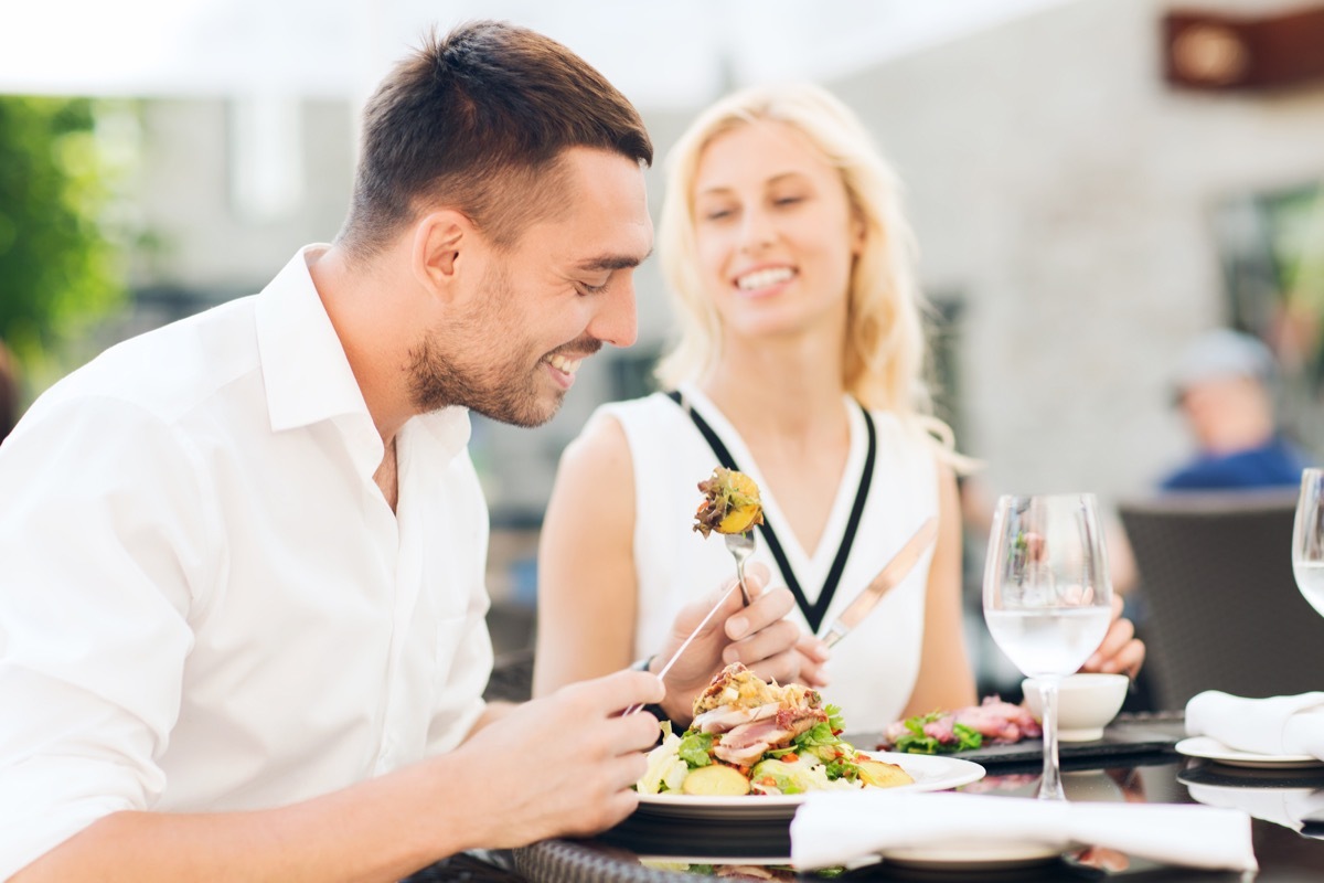 Man and woman eating healthy salad for lunch