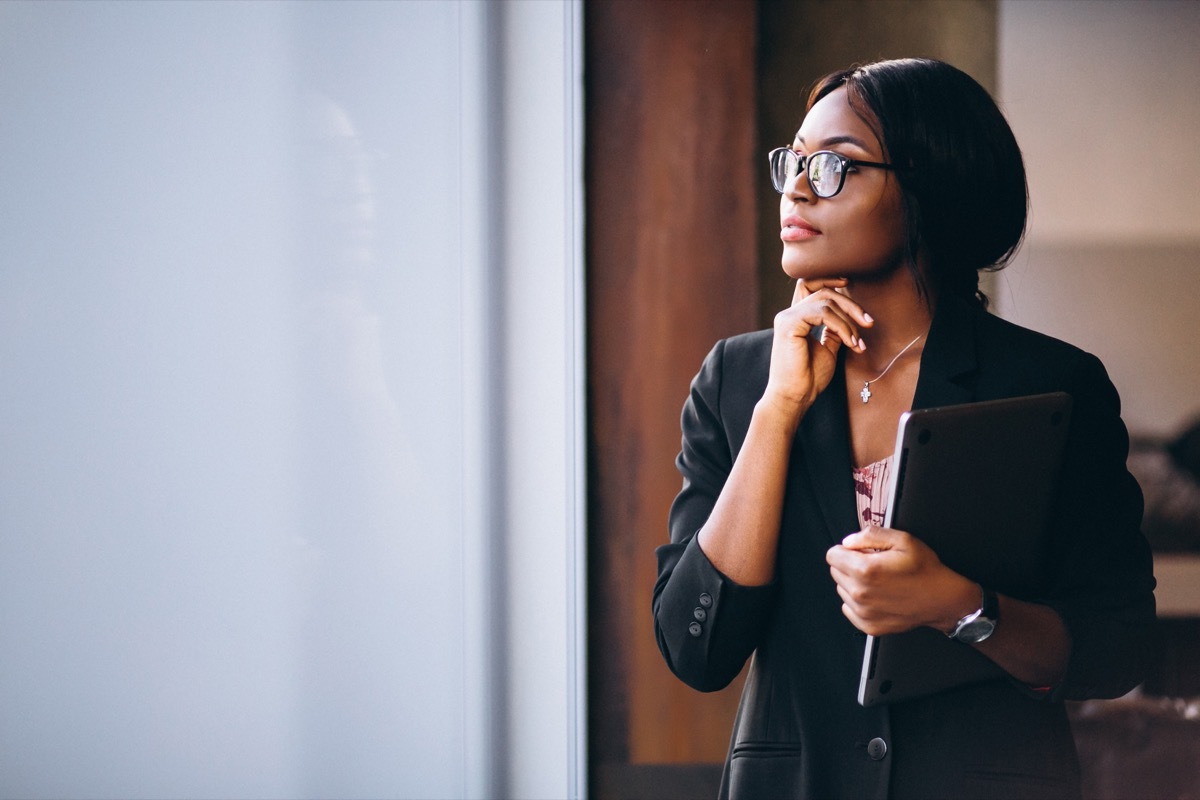 Business Woman thinking in office clothes.