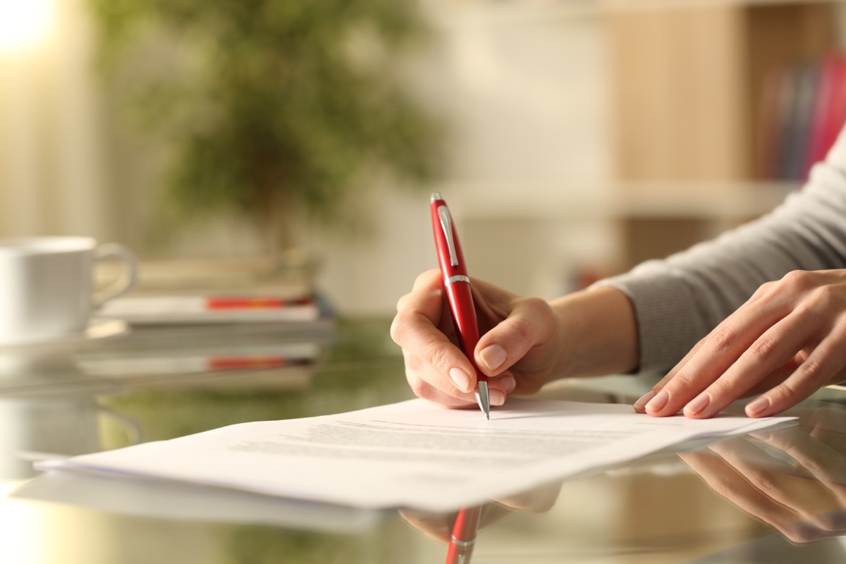 woman signing form